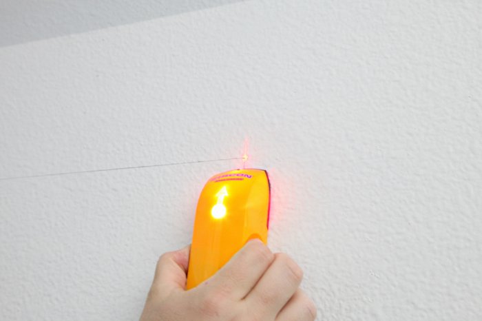 Use a stud finder when measuring your wall. (Photo courtesy of Jennifer Jones/iHeart Organizing)