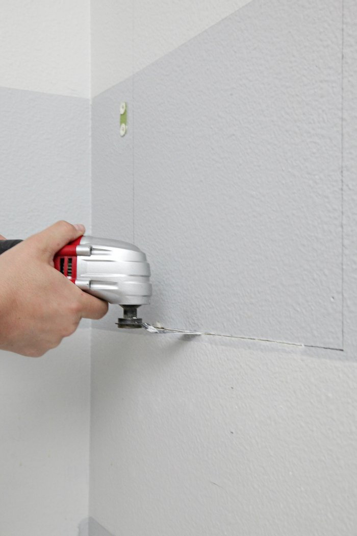Use an oscillating tool to cut away the drywall. (Photo courtesy of Jennifer Jones/iHeart Organizing)