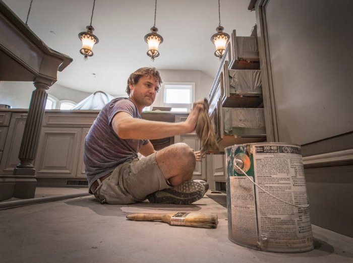 David Studley of Silver Crow Studios finishing kitchen cabinets