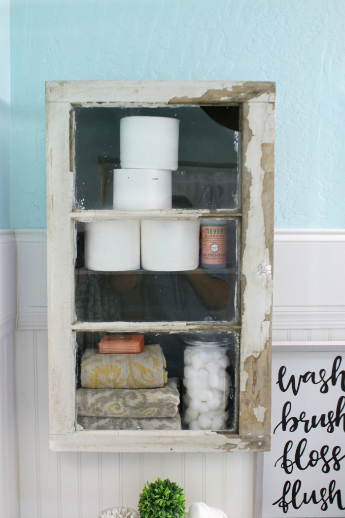 A rustic cabinet added instant storage and style to a small bathroom. (Photo courtesy of Lolly Jane)