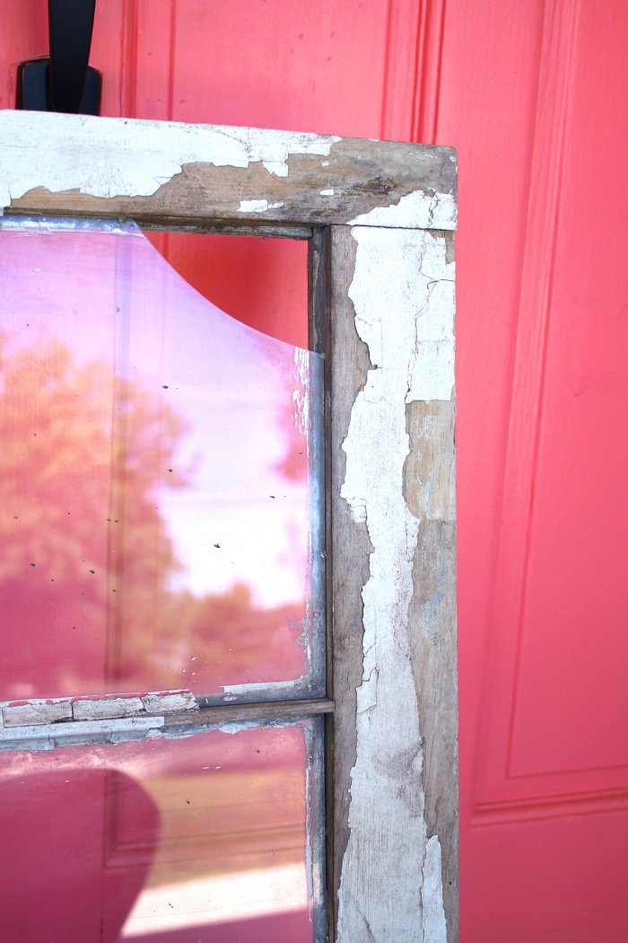 A chipped window makes the perfect cabinet front. (Photo courtesy of Lolly Jane)