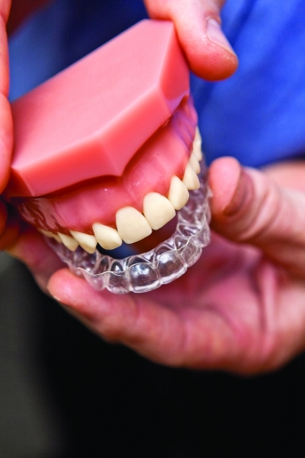 Dentist shows off Invisalign teeth aligners