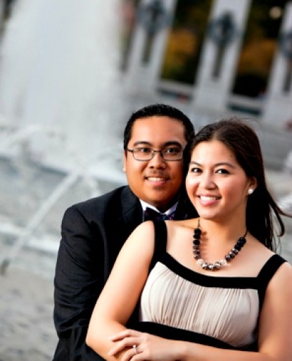 Engaged couple posing in front of World War II memorial