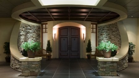 Circular entryway with door illuminated across the top and sides