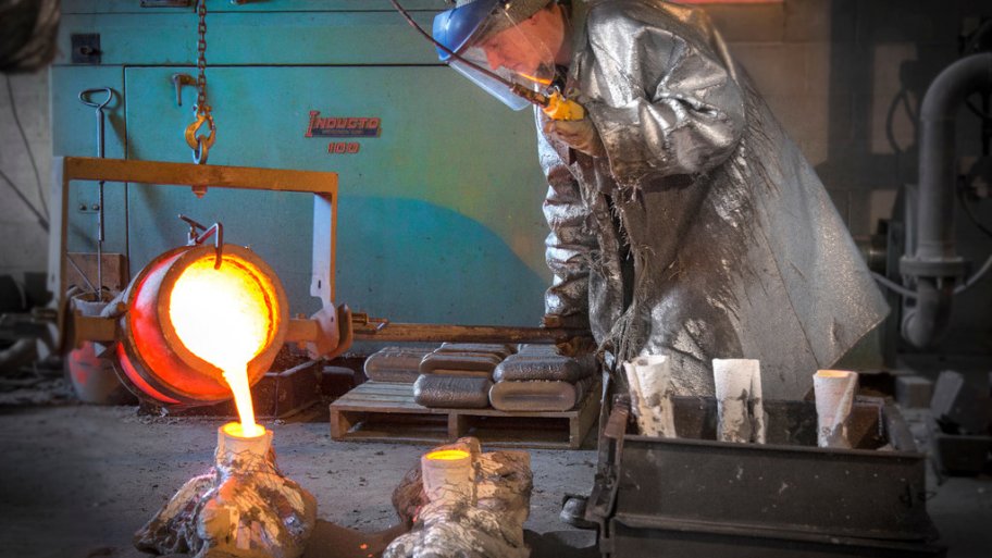 Ryan Feeney of Indy Art Forge pours the mold for his fireman statue's shoes