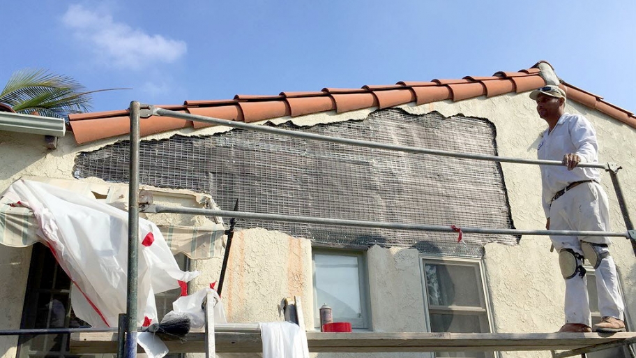 a contractor working on stucco repair