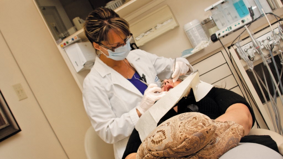 a female dentist working on a woman's teeth