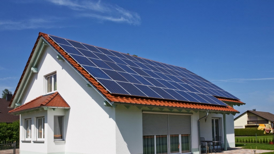 a house with brick shingles and solar panels