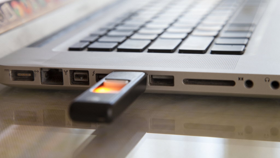 A laptop computer with a flash drive plugged in