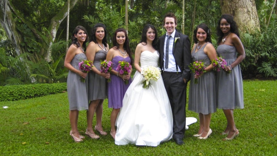 a bride and groom with bridesmaids
