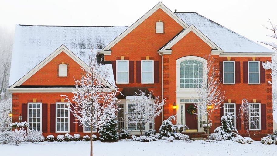 a brick house in winter with snow
