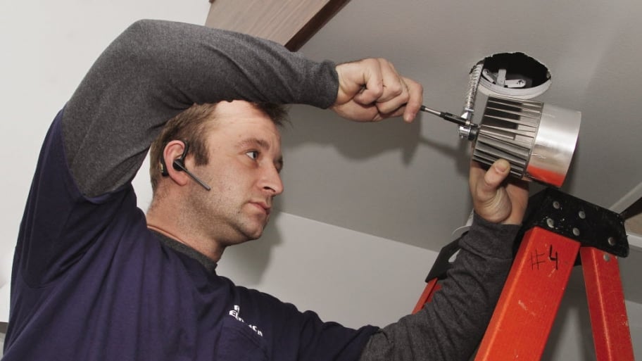 electrician installing an LED light