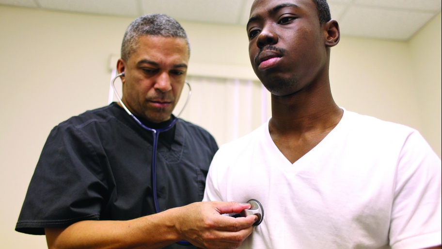 doctor using stethoscope on patient