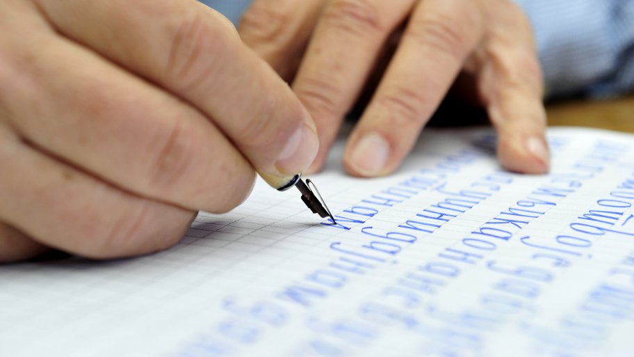 man performing calligraphy