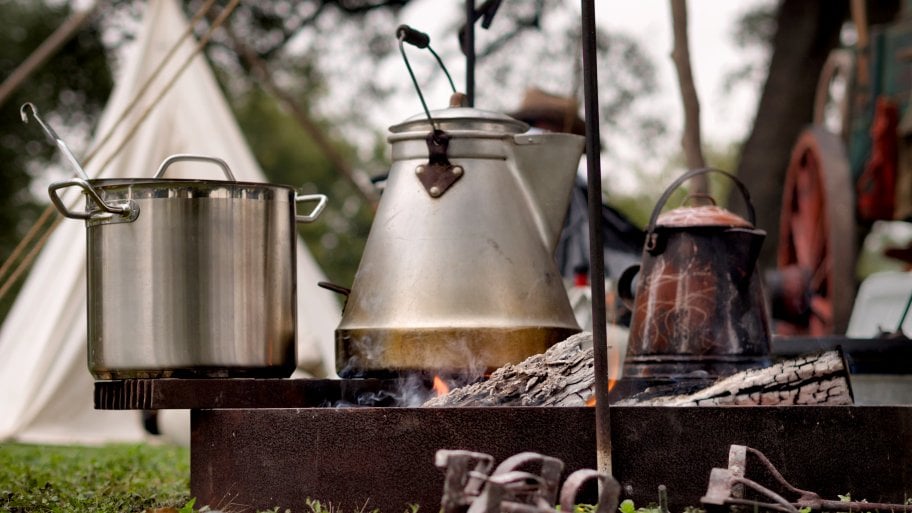 kettle and pot on campfire