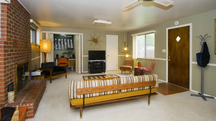 living room with couch, fireplace and ceiling fan