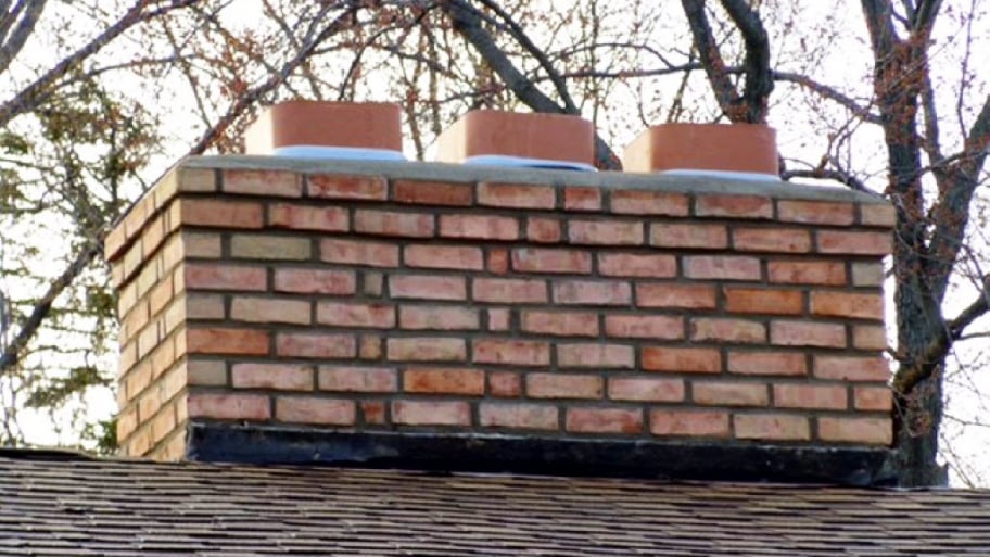 a large brick chimney on top of a house