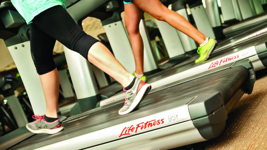 People running on treadmills at a gym.