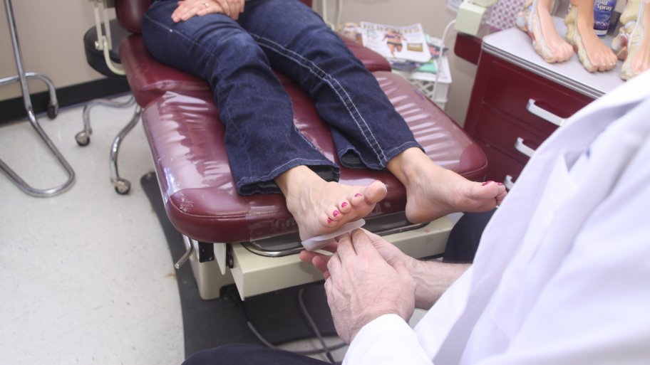 podiatrist looking at patient's feet