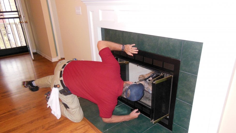 home inspector doing a fireplace inspection
