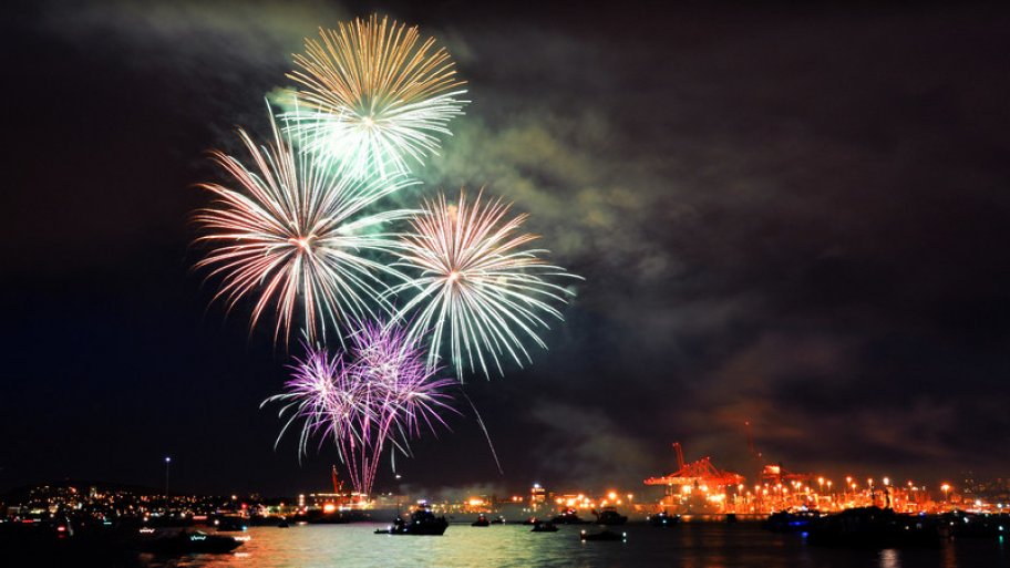 Fireworks over boats in the water.