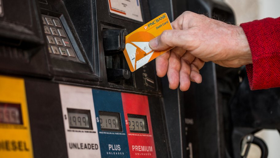Hand with credit card at gas pump