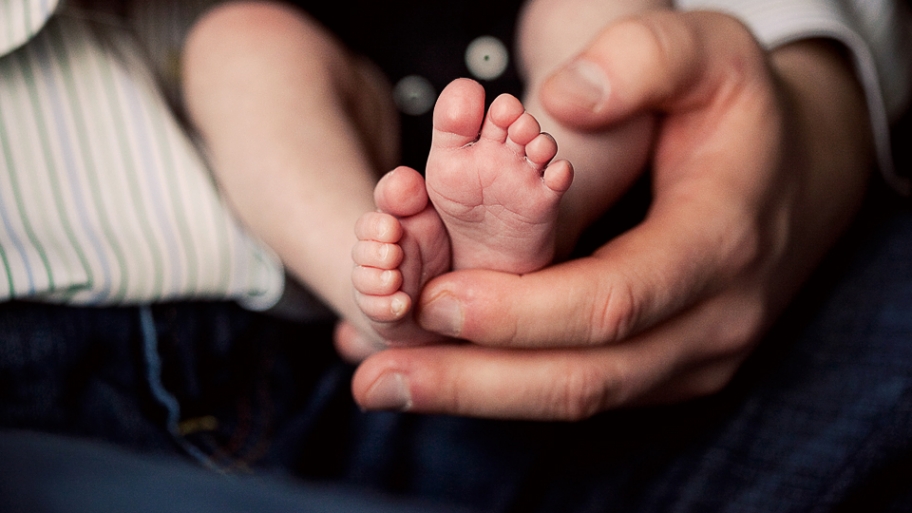 hands holding and infant