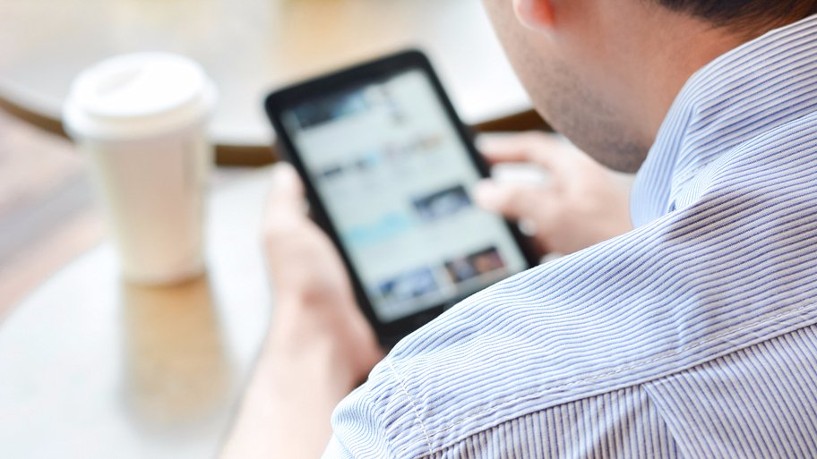 man reading an electronic device