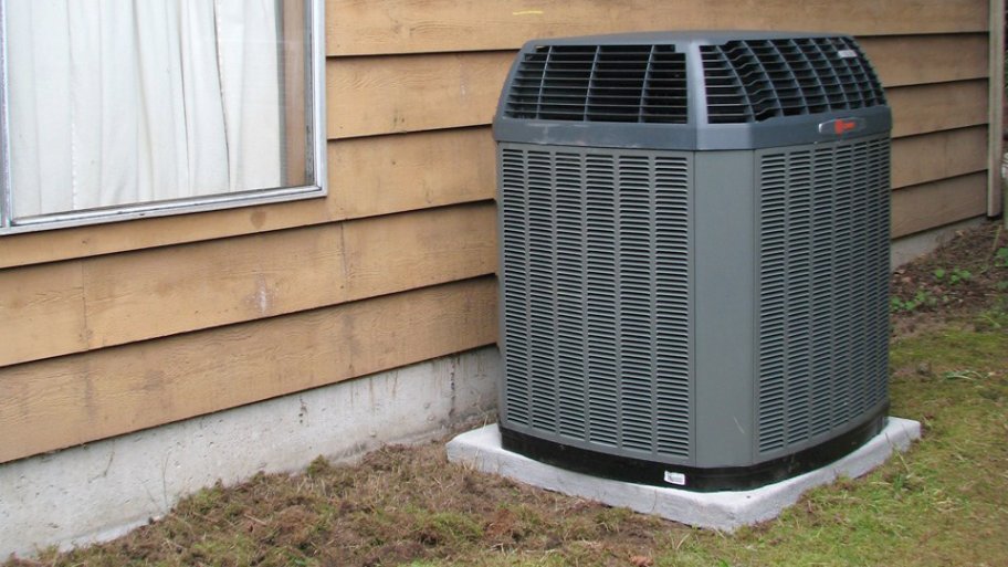 gray heat pump on concrete block