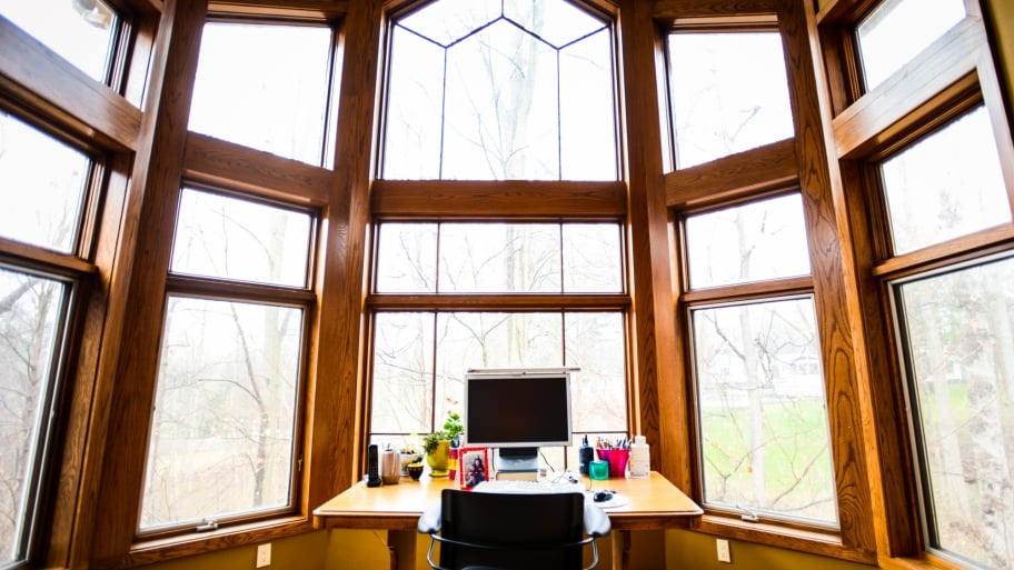 Large windows over a desk in a home office