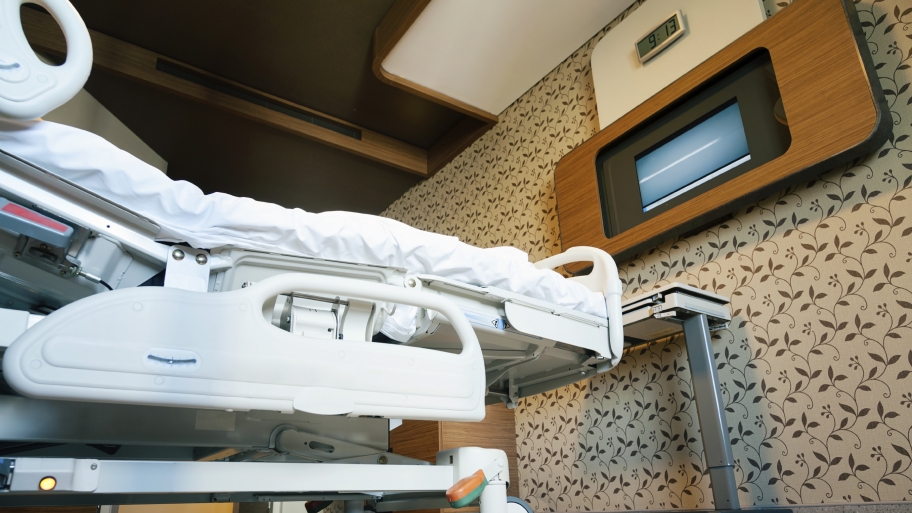 hospital room with bed and TV