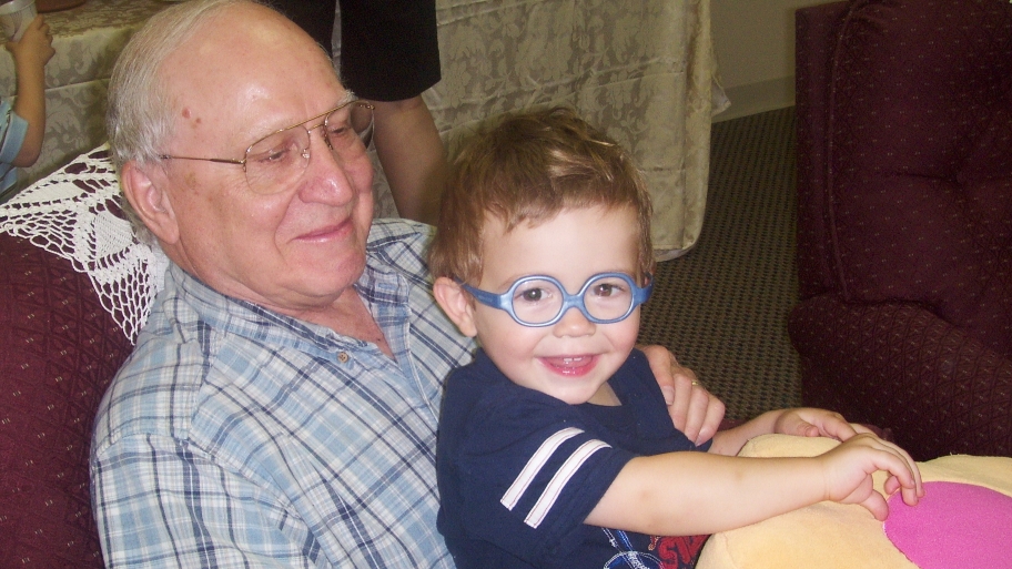 senior gentleman engaging with male child
