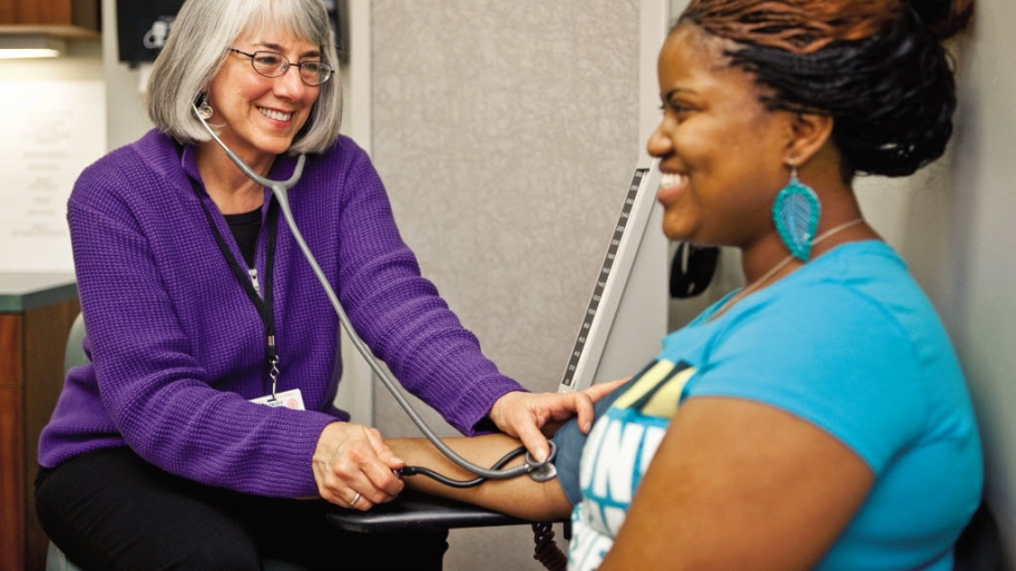 A woman has a blood pressure check
