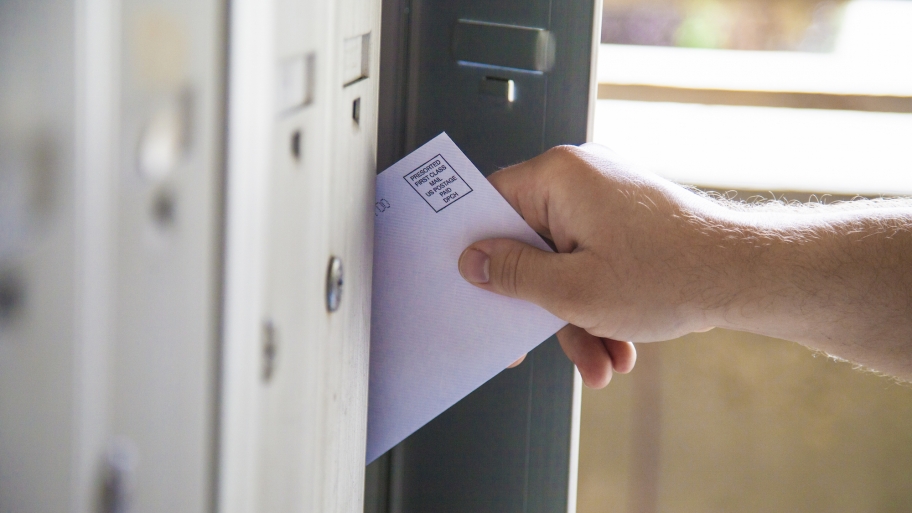 man taking bulk mail from mailbox