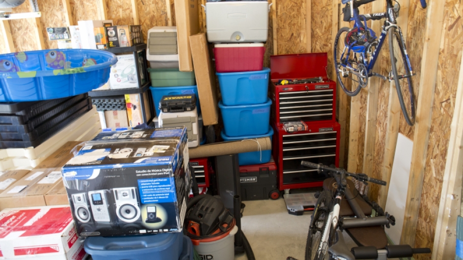 Interior of garage with kiddie pool, bike and other items.