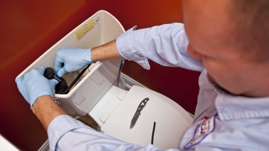 plumber fixing toilet