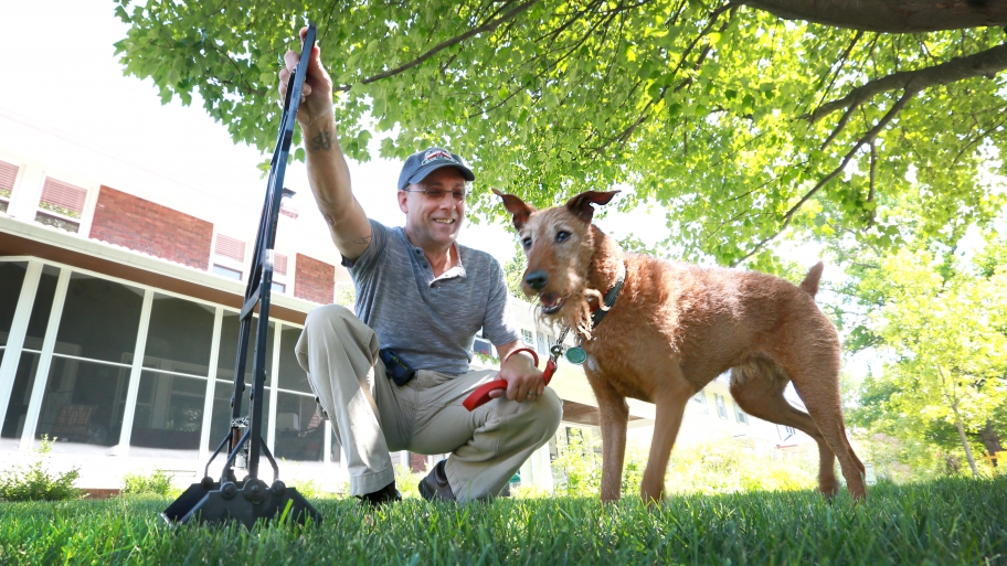 man with dog and pooper scooper