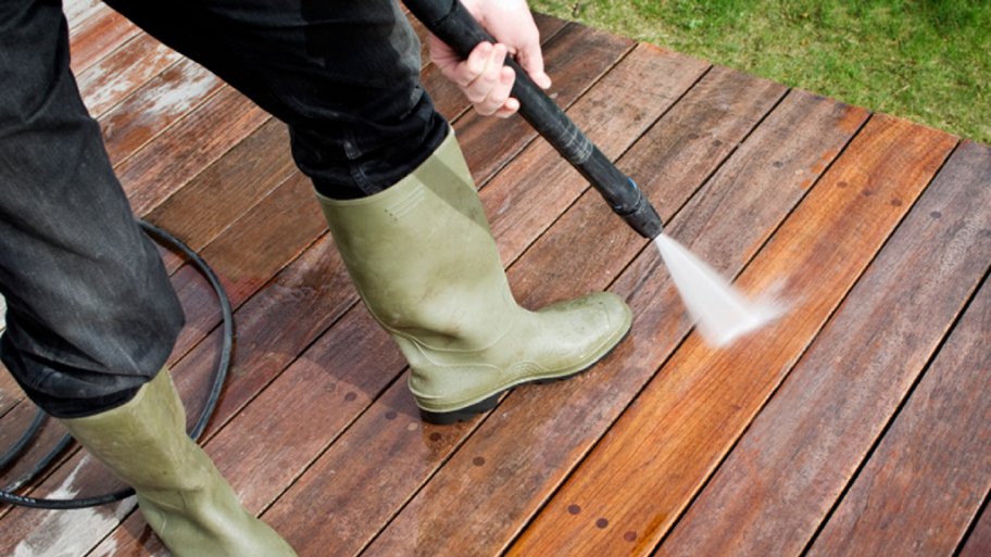 Pressure washer cleaning a deck