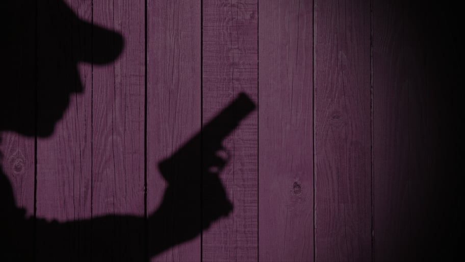 shadow of robber with gun