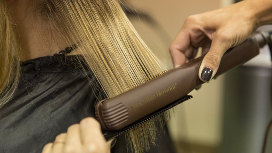 stylist straightening hair