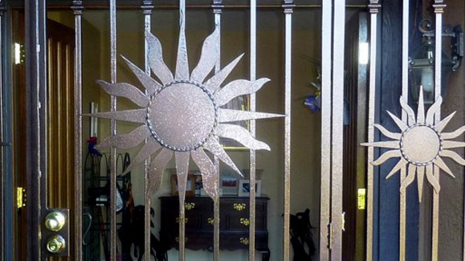 secure front door with metal sun design