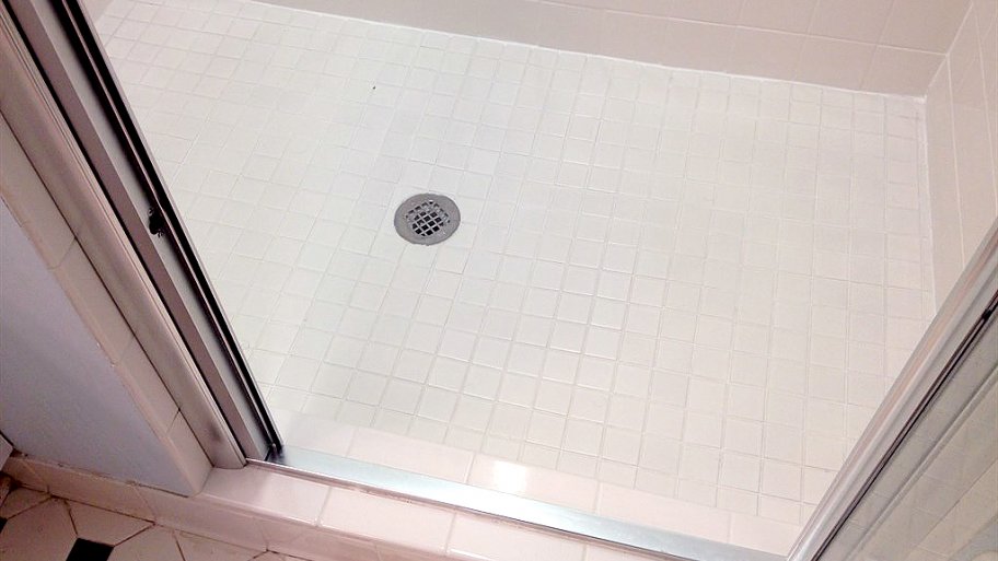 white shower and floor tile with grout