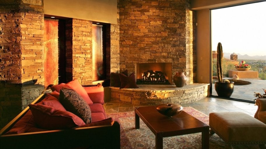 fireplace in living room opening up to a desert scene