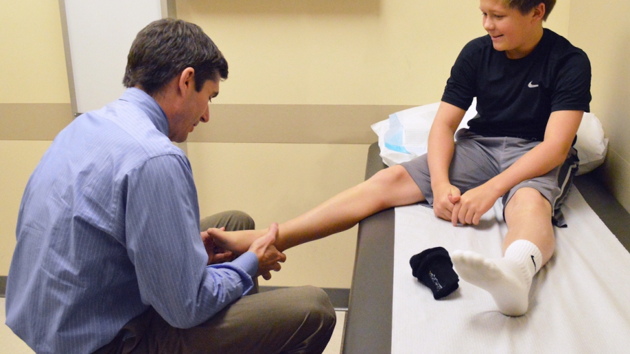 sport medicine doc examining patient's foot