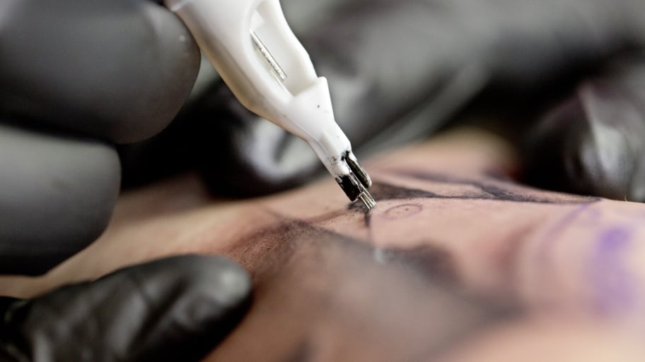 tattoo artist working on a tattoo