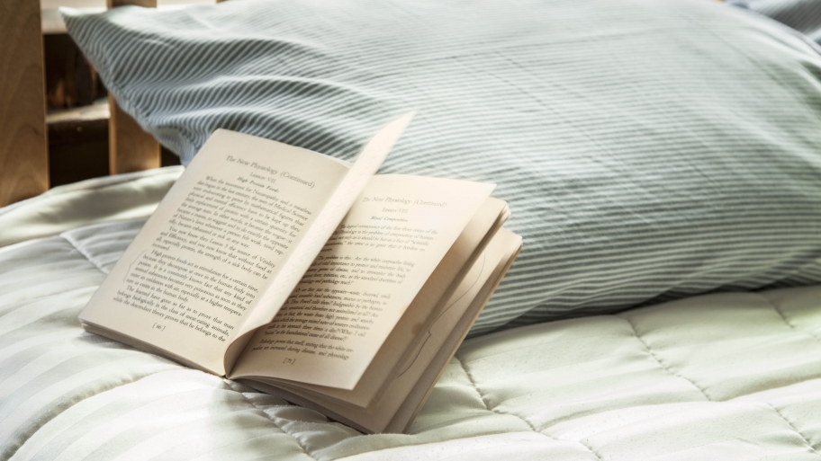 bed with open book