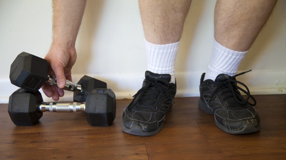 man picking up weights