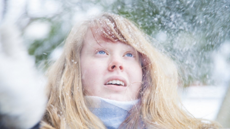 A girl stands in the snow