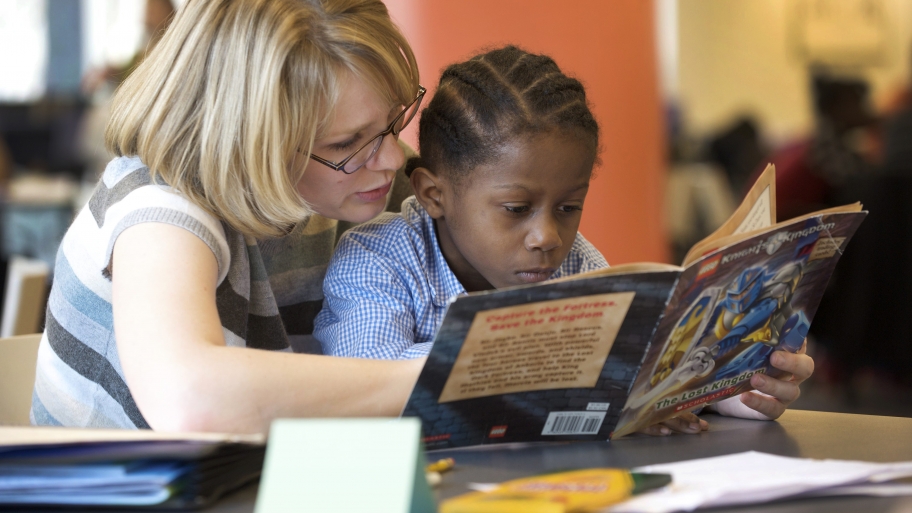 woman tutoring child
