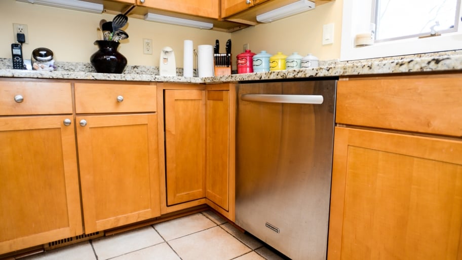 wood cabinets in a green kitchen